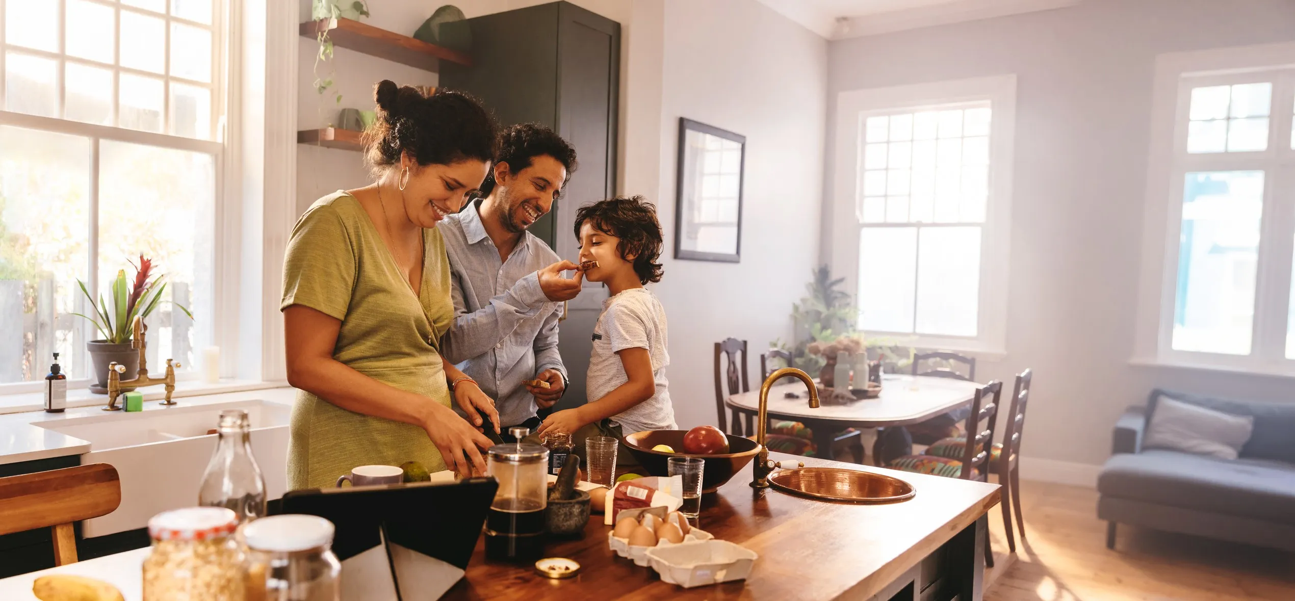 Cheerful family gathers in their kitchen, chopping veggies and mixing ingredients for a delicious home-cooked meal